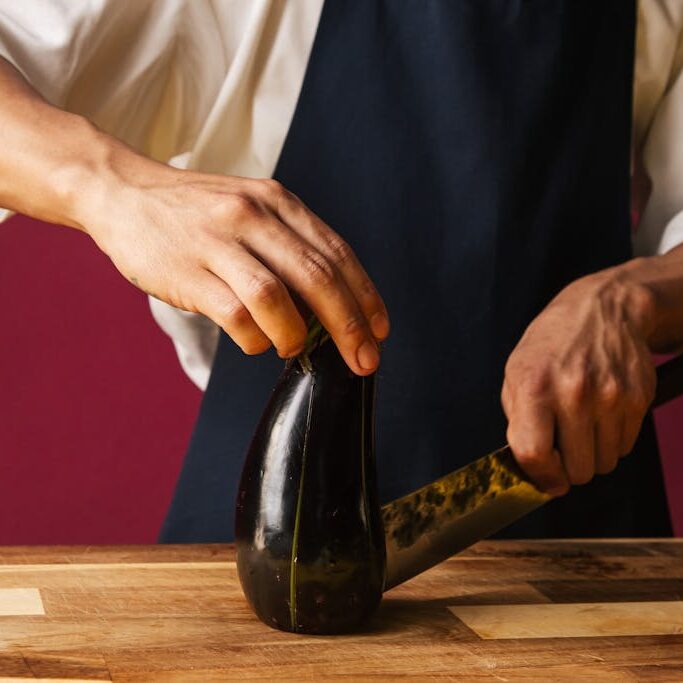 Person Cutting an Eggplant